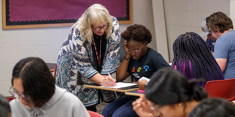 Professor helping student.