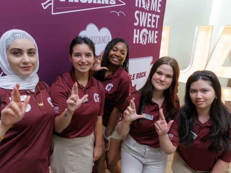 Five female students at orientation making the 
