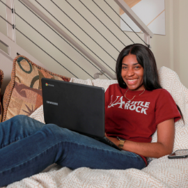 Student relaxing with laptop.