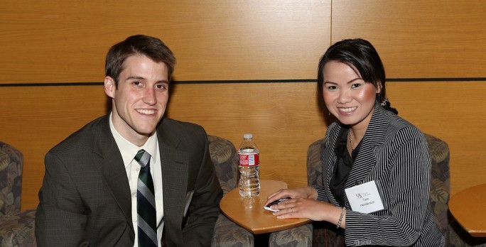 Meet the Firms Mixer - two students seated in the Atrium