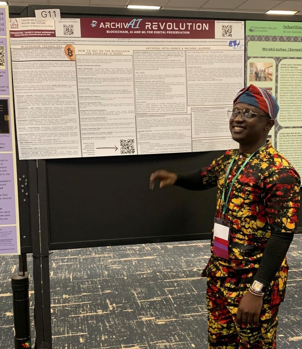 A graduate student at a conference presents his poster presentation titled "ArchivAI Revolution: Blockchain, AI and ML for Digital Presentation"