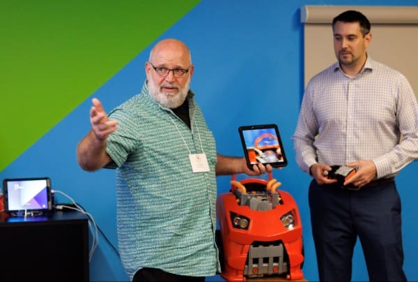 Emerging analytics center employees demonstrating virtual and augmented reality technology