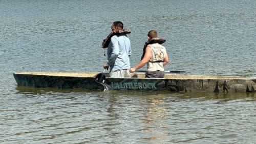 the team effectively using the canoe and staying afloat in a shallow lake