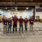 UA Little Rock ASCE students mid-south expo participants standing in front of completed steel bridge project