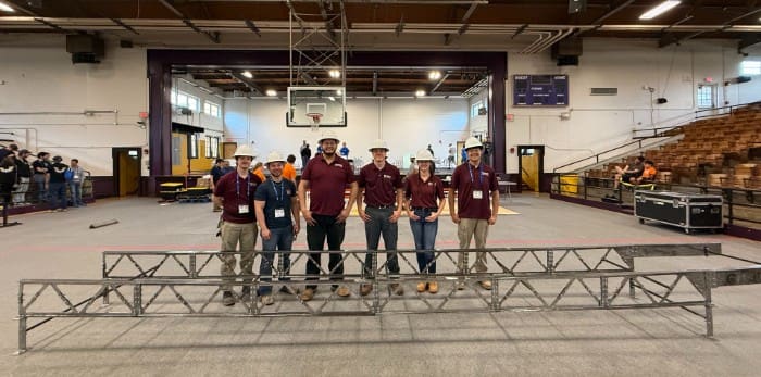 UA Little Rock ASCE students mid-south expo participants standing in front of completed steel bridge project