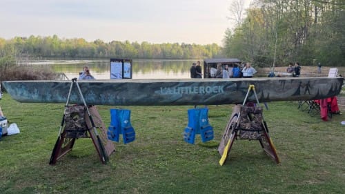 Finished concrete canoe with ua little rock painted on the side