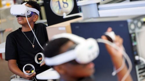 young people using virtual reality headsets during vr summer camp activity
