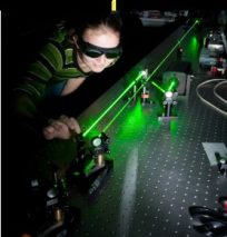 Woman researcher using laser.