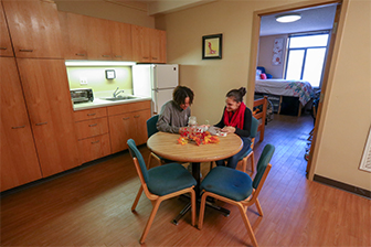 Two students studying together in the common area of a dorm room in East Residence hall.