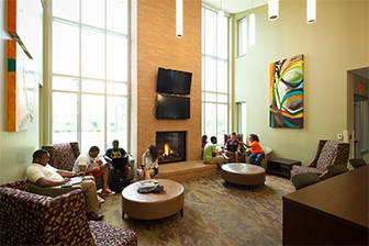 A group of students hang out in the lobby of West Residence Hall.