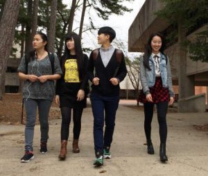 Four international students walking on campus.