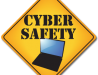 Image of a yellow yield traffic sign that contains a photo of a laptop computer and the words "CYBER SAFETY'.