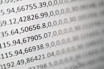 Random printed numbers on white paper representing data encryption.
