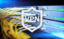 VPN logo on a shield, background is image of many cables leading from back of a computer server