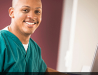 Photo of male student smiling, dressed in green scrubs, caption reads 'UA Little Rock Online'..