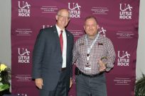 Photo of V.C. Jerry Ganz and Russ Riegel ITS Client Support Mgr. standing side by side. Russ is holding the glass tear-drop shaped award.