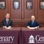 Dr. Christopher Holoman and Dean Colin Crawford sign the agreement.