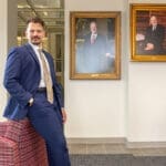 James Gathright stands in the Dean's Gallery at the UA Little Rock William H. Bowen School of Law