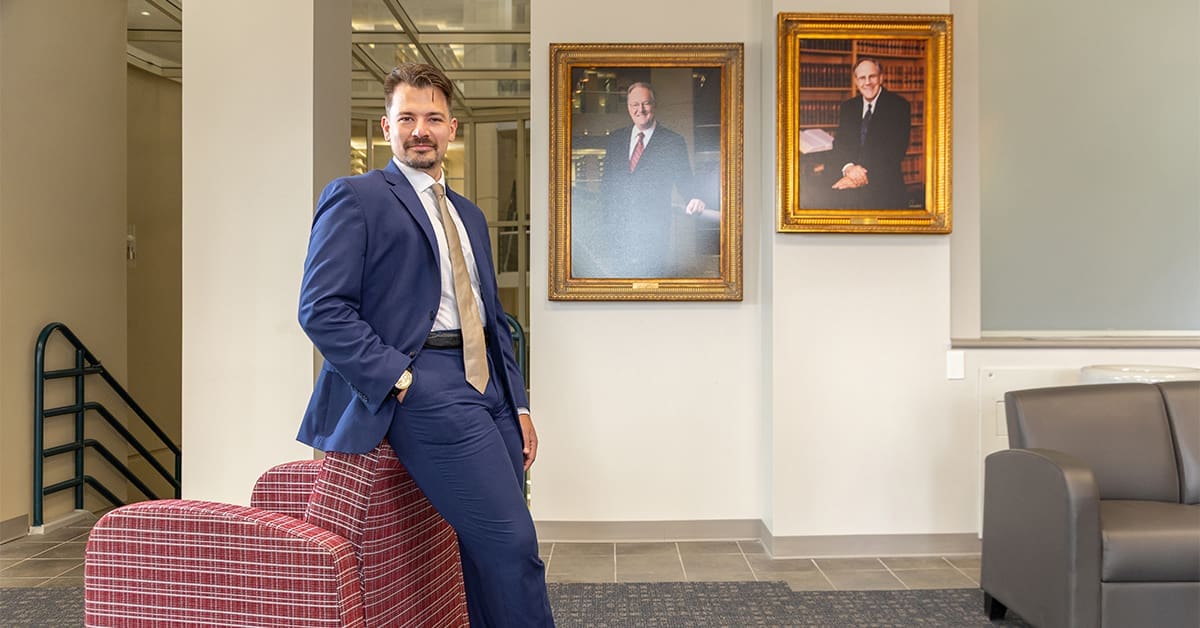 James Gathright stands in the Dean's Gallery at the UA Little Rock William H. Bowen School of Law