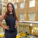 Erica Hawkins stands in the law library at the UA Little Rock William H. Bowen School of Law.