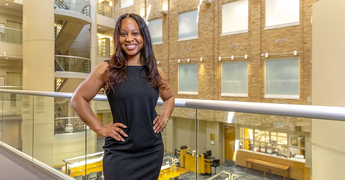 Erica Hawkins stands in the law library at the UA Little Rock William H. Bowen School of Law.