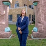 Chacey Schoeppel Wilcox stands in front of the UA Little Rock William H. Bowen School of Law