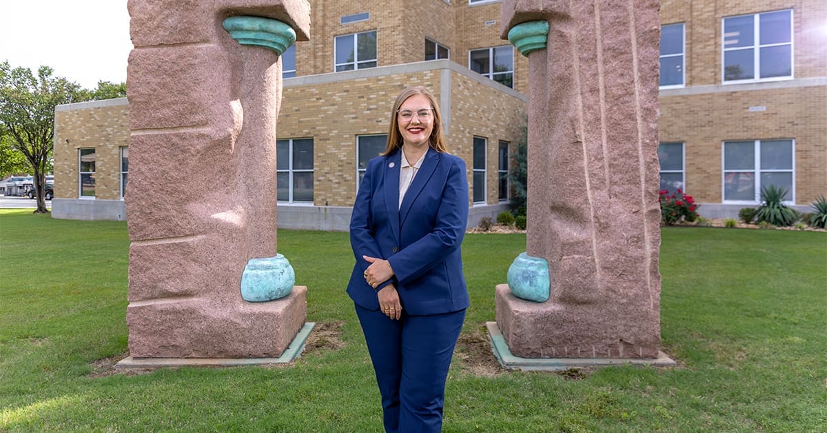 Chacey Schoeppel Wilcox stands in front of the UA Little Rock William H. Bowen School of Law