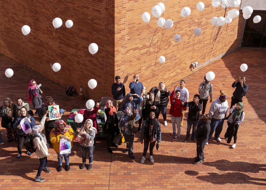 The campus community released white balloons of love and hope in honor of women who have been victims of physical attacks and policy discrimination because of their choice to wear the hijab. Photo by Ben Krain.