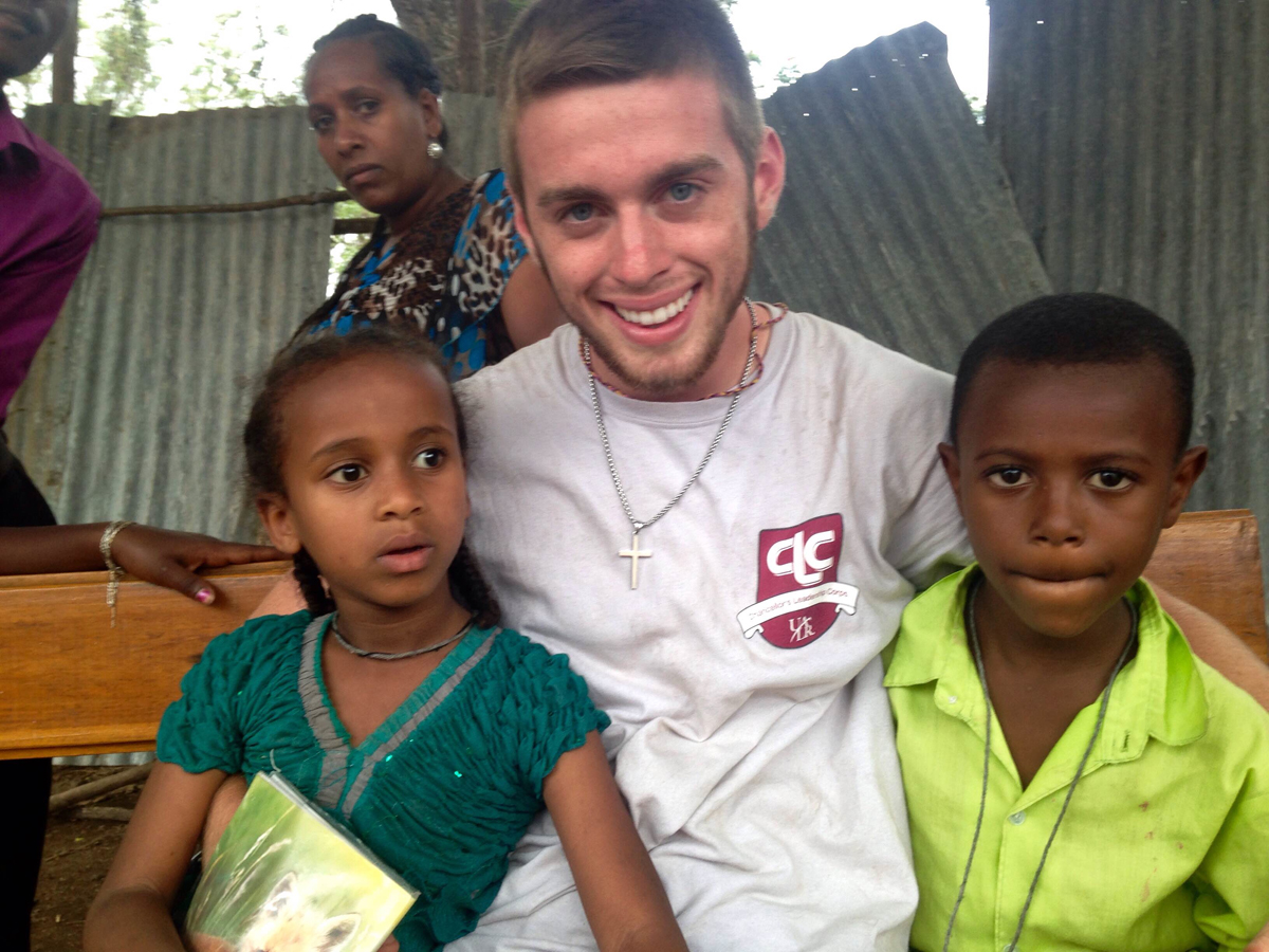 James Sellers poses with two children he met during a missions trip