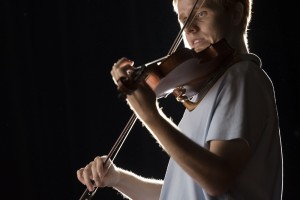 UALR student and traditional-style fiddler Everett Elam photographed while playing the fiddle
