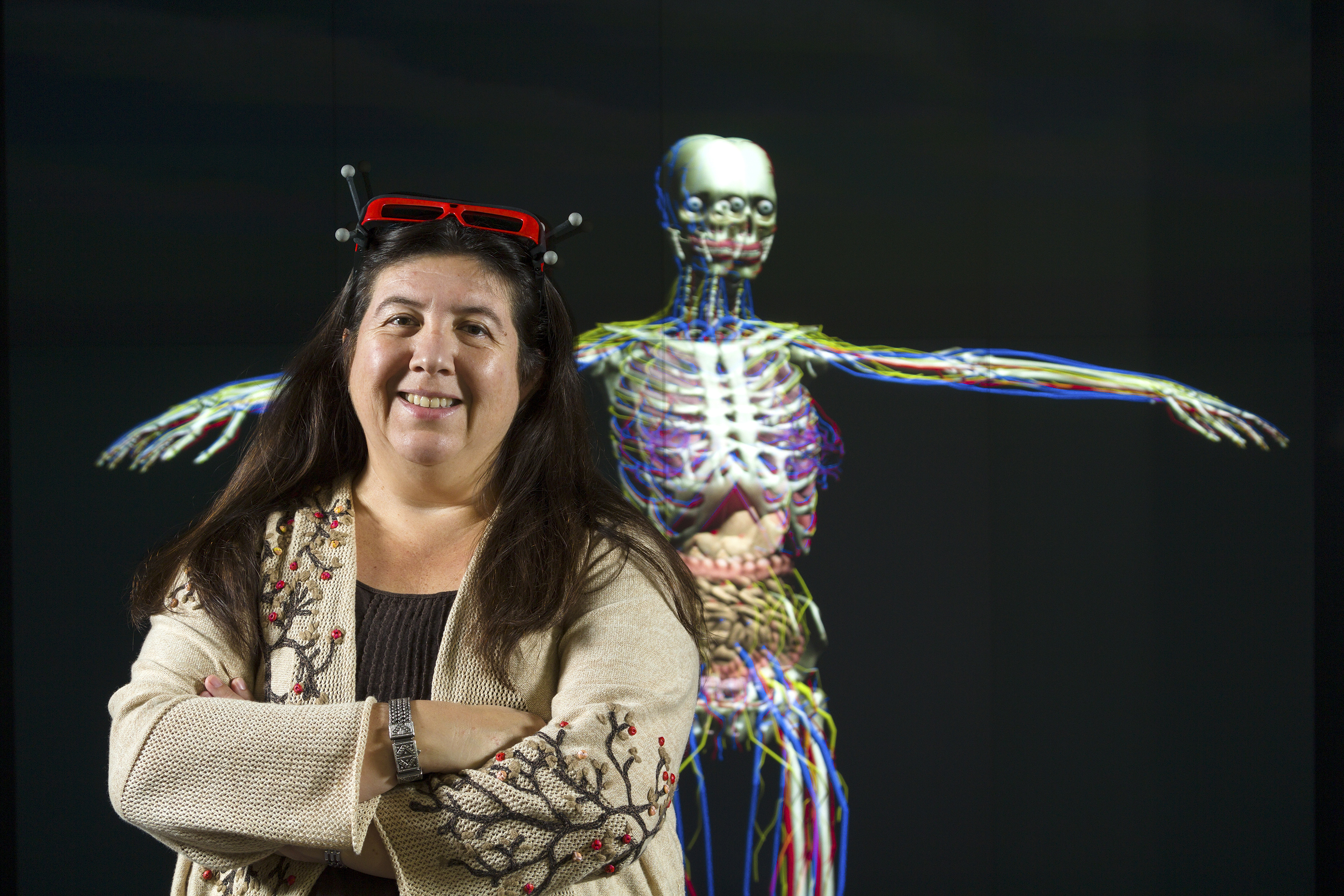 Dr. Carolina Cruz-Neira with a virtual human skeleton in the background