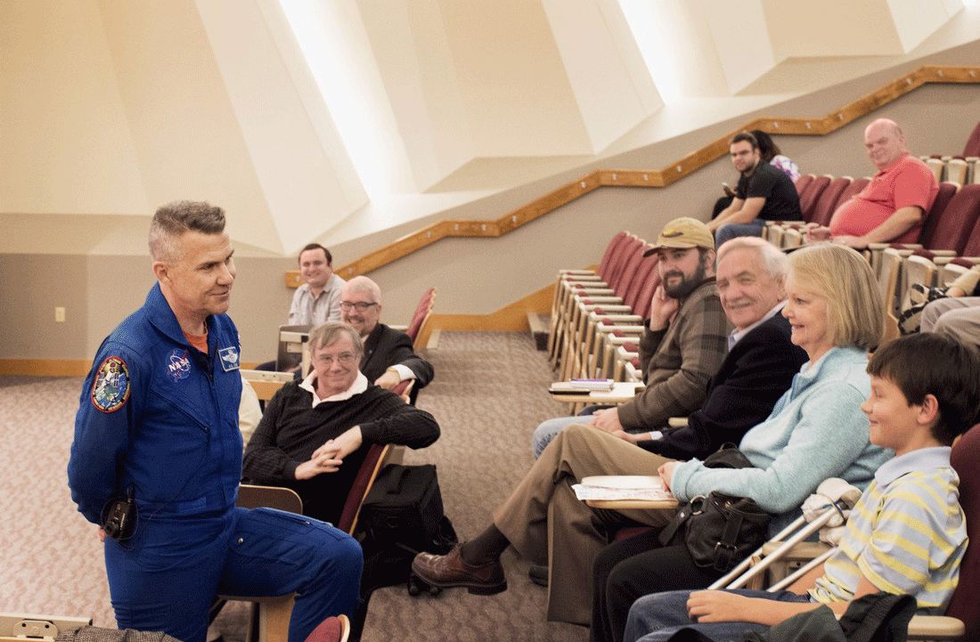 Former astronaut Duane "Digger" Carey speaks to a student about his 2002 mission to the Hubble Space Telescope during a colloquium at UALR on Feb. 25.