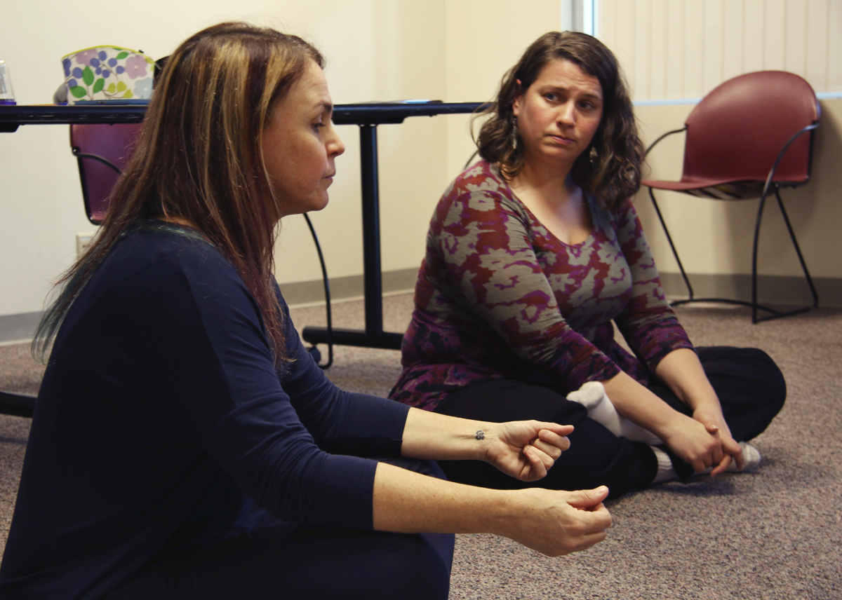 Maria Carvalhaes sits in a circle with the participants of her mindfulness class.