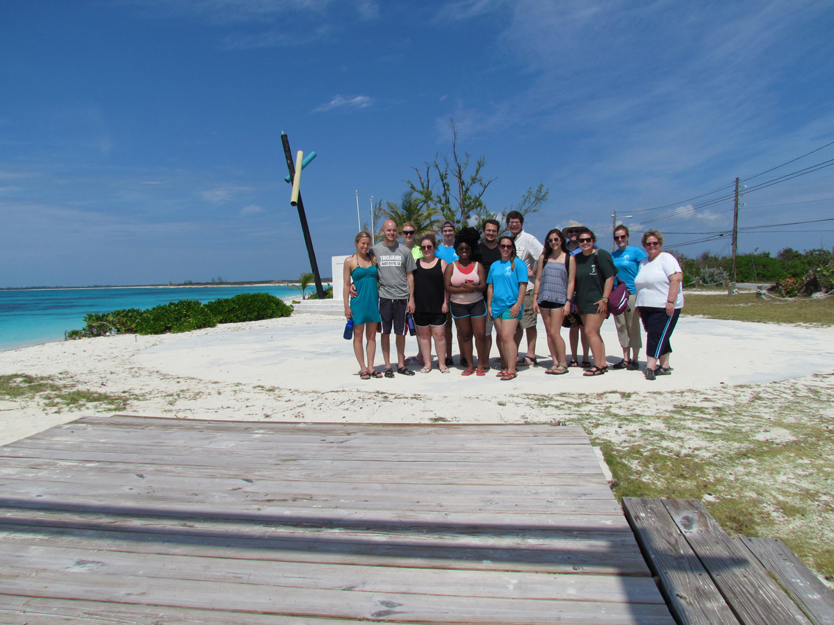 A group shot of the students next to the ocean.