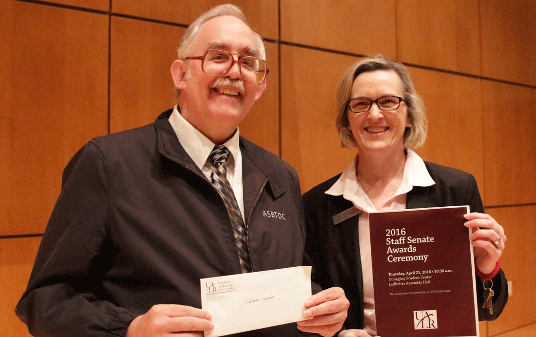 Tim Lee, a training specialist with the Arkansas Small Business and Technology Development Center, receives the Personal Growth Award at the 2016 UALR Staff Achievement Awards Ceremony with Interim State Director Laura Fine.