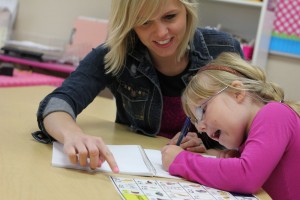 Staff at Nixa School District in Missouri work with a student on a reading lesson. UALR is involved in a Reading Recovery effort in a St. Louis-area school. 