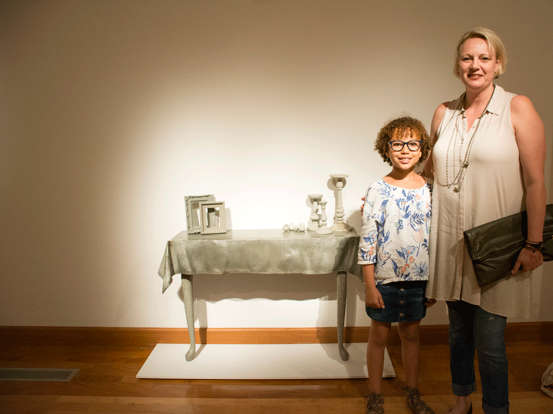 UALR artist MIa Hall stands next to her artwork with her daughter, Fiona Clemmons.