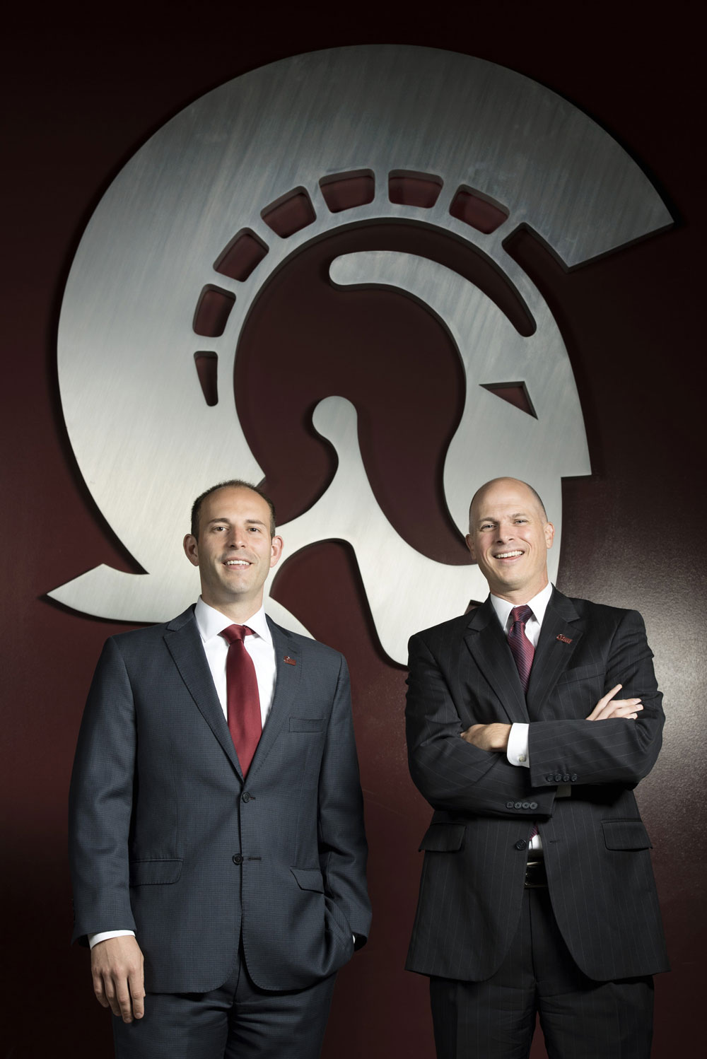 UALR's Chasse Conque and Christian O'Neal pose in front of a large Trojan logo