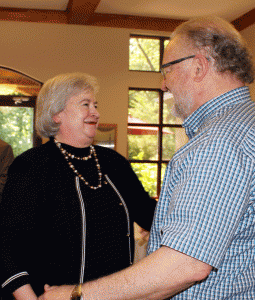 Paula Casey (left) greets a friend during her June 16 retirement celebration at the UALR Bailey Center. 