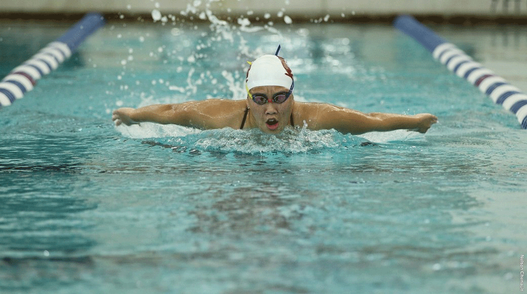 A University of Arkansas at Little Rock swimming and diving team member races in competition.
