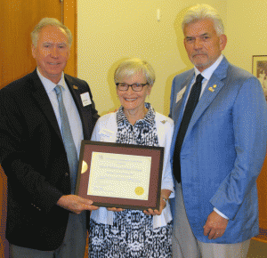 Chancellor Andrew Rogerson (left) presents a plaque to honor new Heritage Society members Elaine Eubank (middle) and Alfred Williams (right). 