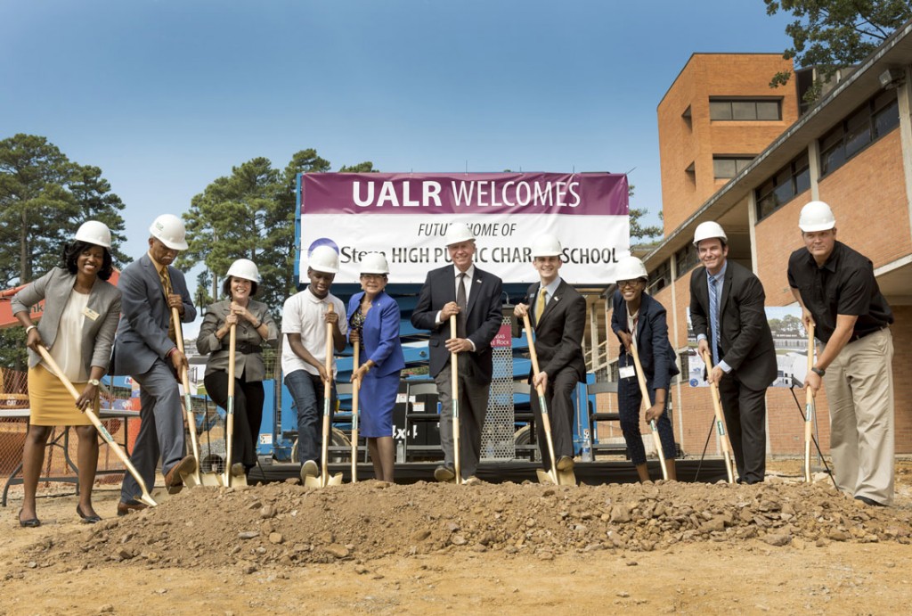 Officials from eStem and UALR break ground during a ceremony at the future site of eStem High School.