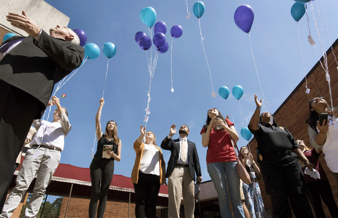 UALR students and employees release balloons and messages for those affected by suicide Sept. 22 at UALR.