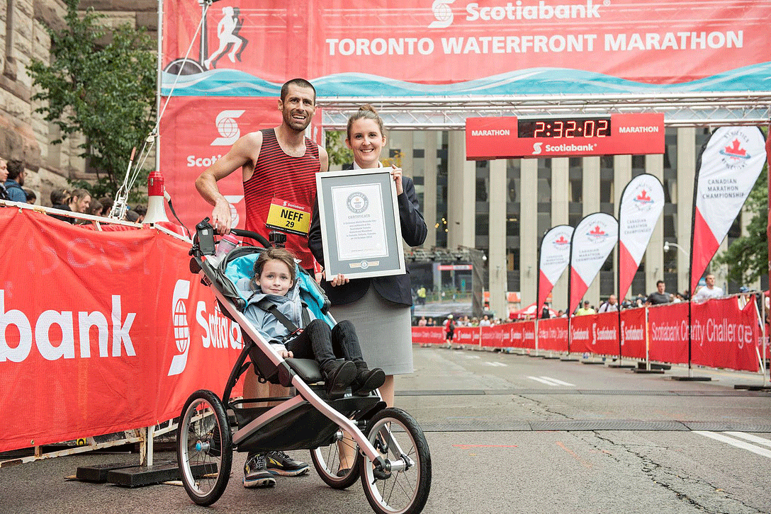 Calum Neff receives a certificate for breaking the Guinness World Record for fastest marathon pushing a pram at the Scotiabank Toronto Waterfront Marathon on Oct. 16. Photo from Guinness World Record.