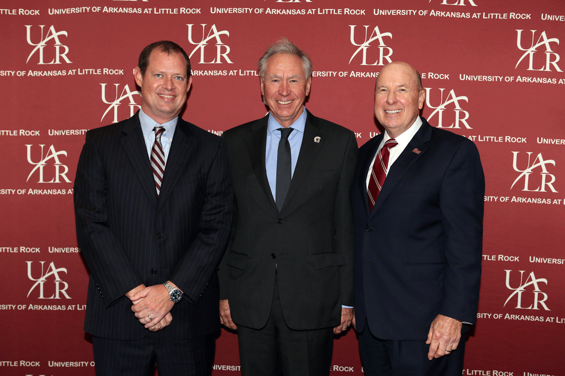 UALR Chancellor Andrew Rogerson (center) congratulates award recipients Mark Pollack (left) and Thomas Dickinson (right) during the College of Business Distinguished Alumni Luncheon.