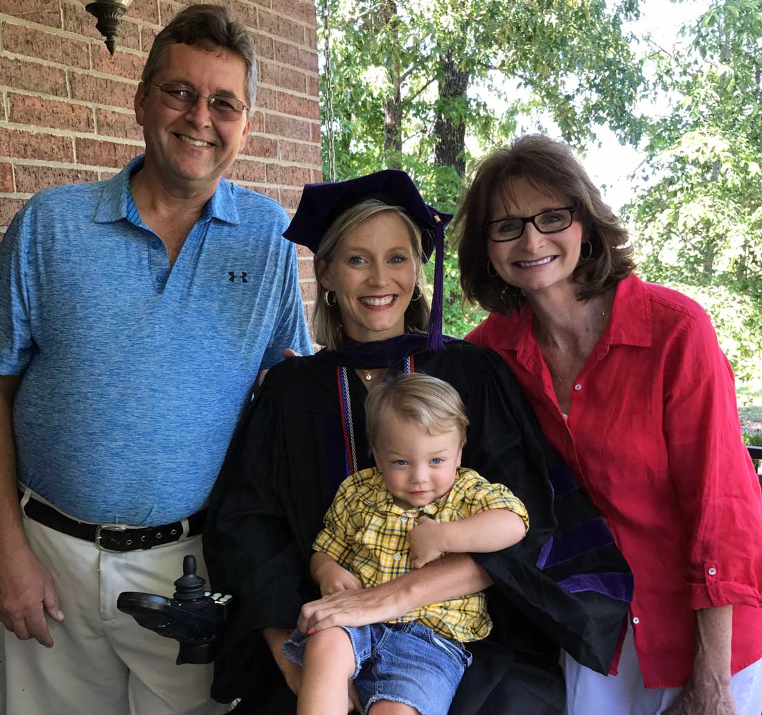 Jennifer Goodwin celebrates her graduation from Bowen School of Law with her parents, Robby and Tracy Goodwin, and son, Beckham.