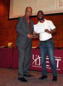 Vernard Henley (left) presents Adewale Obadimu (right) with second place in the EIT Grad Award. 