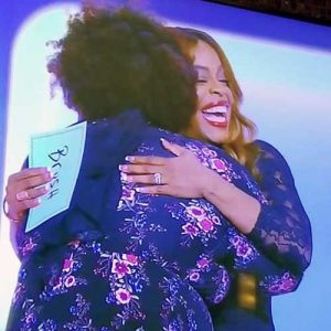 Cheryl Humphrey hugs celebrity panelist Niecy Nash after Humphrey won $10,000.