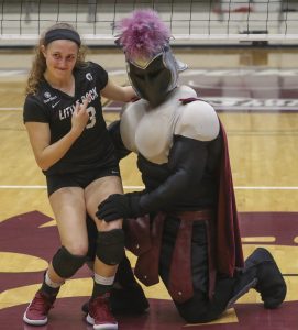 Sydnee Martin poses for a picture with the Trojan mascot shortly he reveals himself as her boyfriend, Jacob Bland. Photo by Ben Krain. 