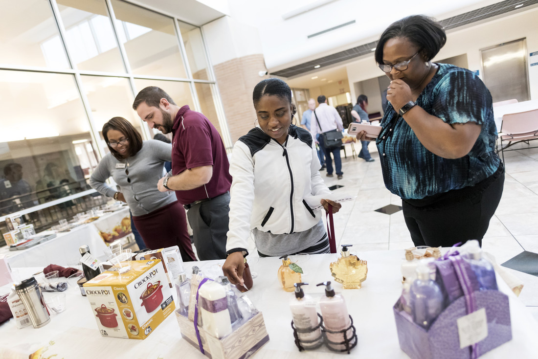UA Little Rock employees browse the teacup auction during the 2017 Staff Senate Fall Open House.